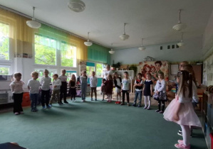Grupa dzieci stoi podczas występu w sali przedszkolnej. Ujęcie 4
